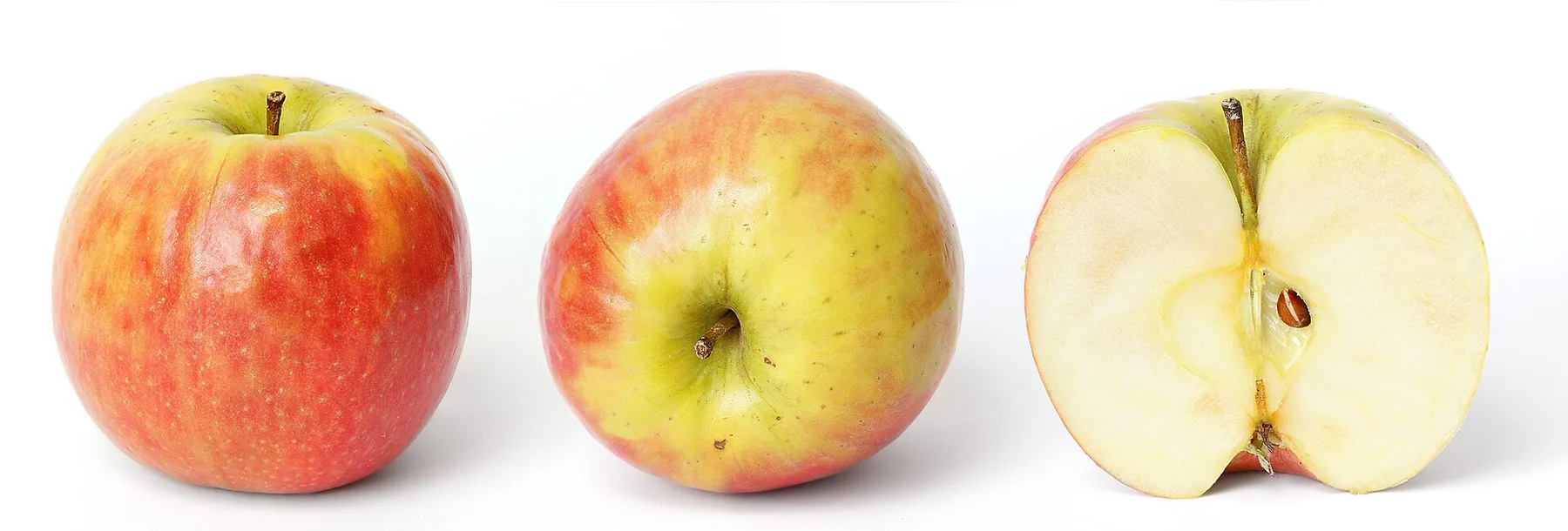 Two whole Pink Lady apples and one cut half on a white background.